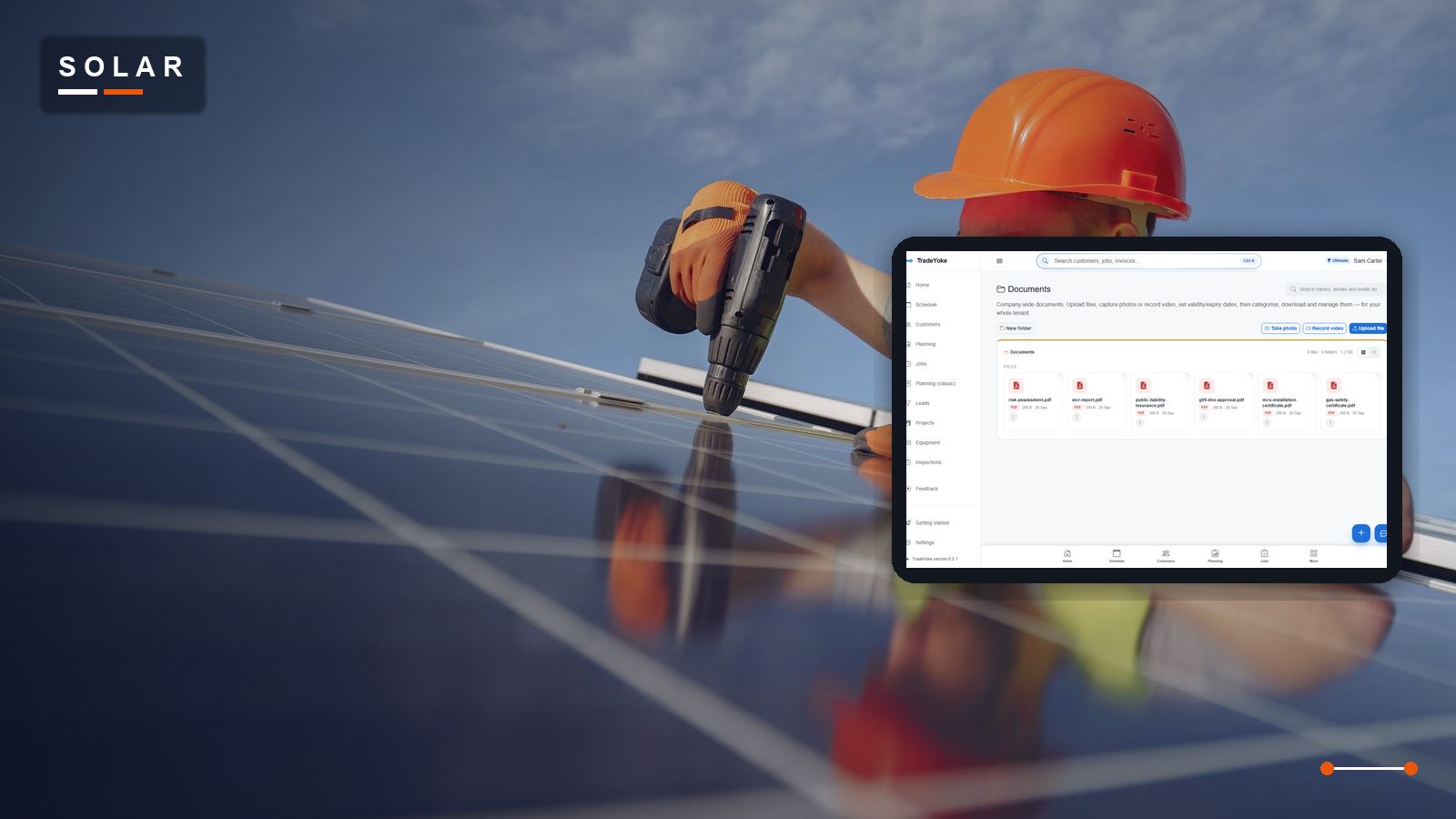 A solar installer on a roof beside newly fitted panels, beside TradeYoke's document library holding the G98/G99 paperwork